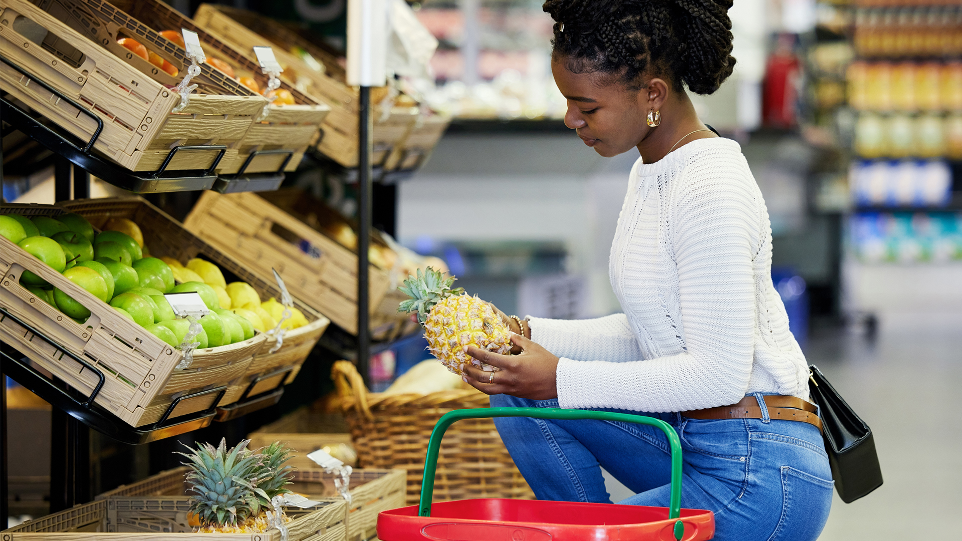 Woman, grocery shopping and fruits choice, discount and sale or wholesale promotion for healthy food and basket. African customer in convenience store or supermarket